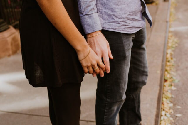 a couple is holding their hands